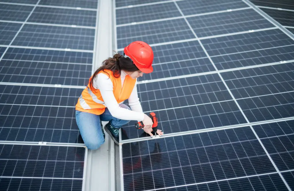 Technician fixing a solar panel