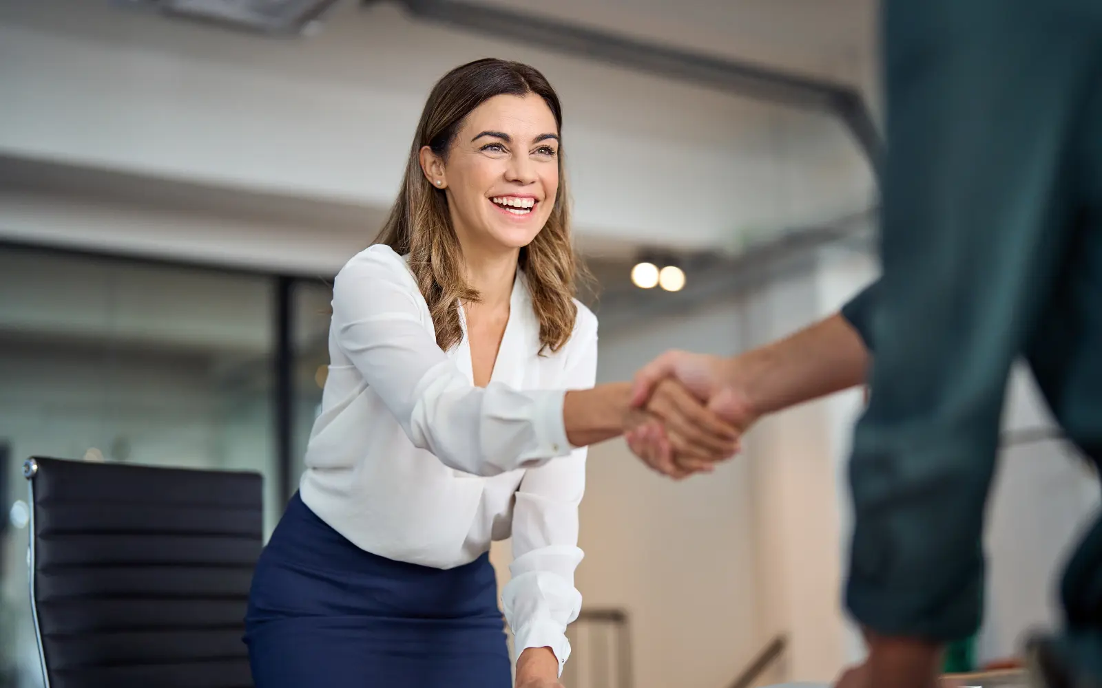 Women shaking hands in a business meeting